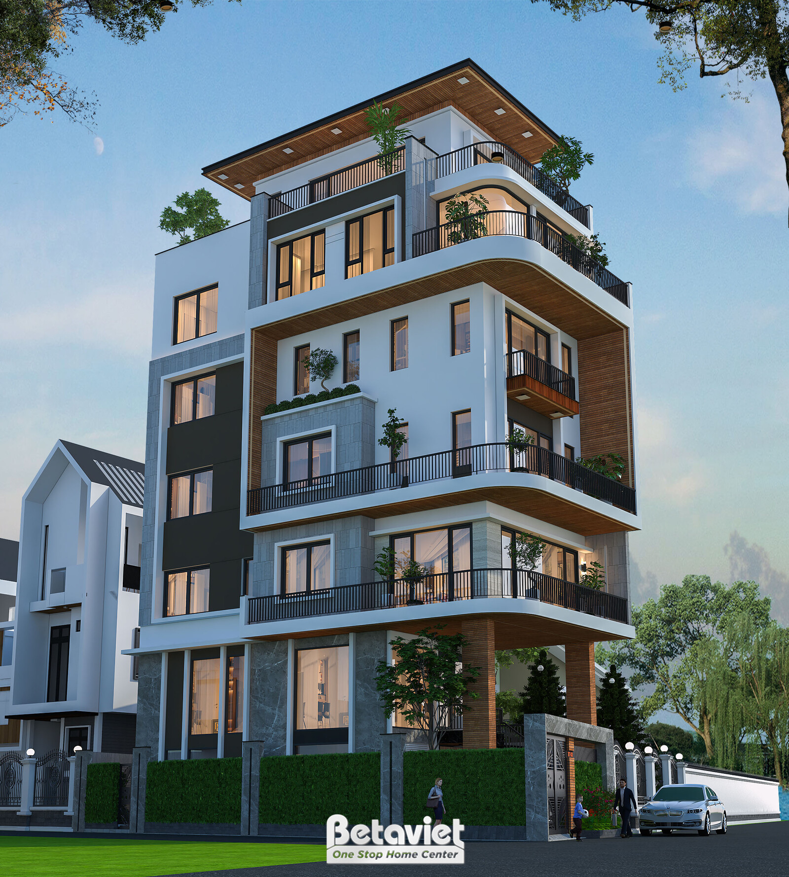 Góc chéo mặt tiền cho thấy đồng thời mặt chính và mặt hông công trình. Mặt chính ốp gỗ nâu, sơn trắng bo cong; mặt hông ốp…